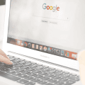 Someone typing on a laptop with Google on their screen. Showcasing one section of paid media opportunities.