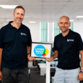Simon Beer and Tom Gozna with Real Living Wage logo