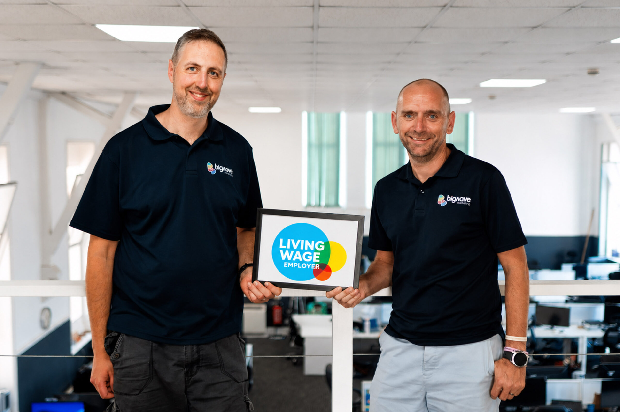 Simon Beer and Tom Gozna with Real Living Wage logo